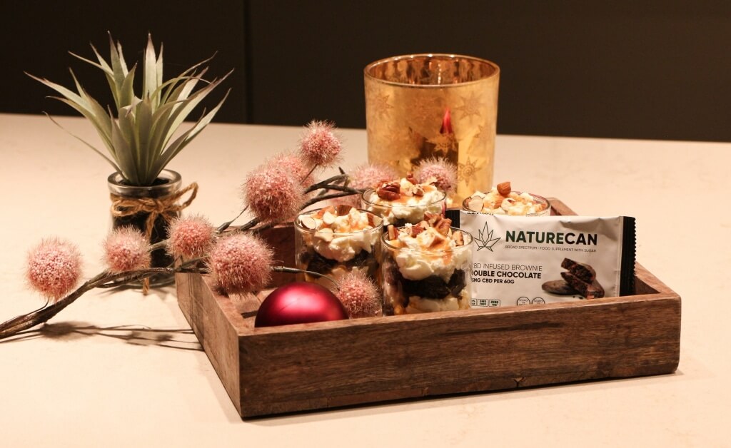 a wooden tray filled with food and a candle.