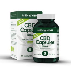 a bottle of cbd capsules next to a box of cbd capsules.