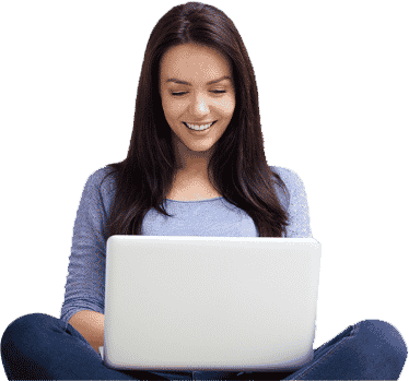 a woman sitting on the floor using a laptop.