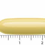 A yellow oblong Vitakruid Fish Oil Forte softgel capsule (1000mg, 90 pieces) is shown next to a ruler, measuring about 2.2 cm long.